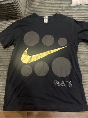 Comme des Garcons Black Tee with Gold Swoosh and Circle Graphic
